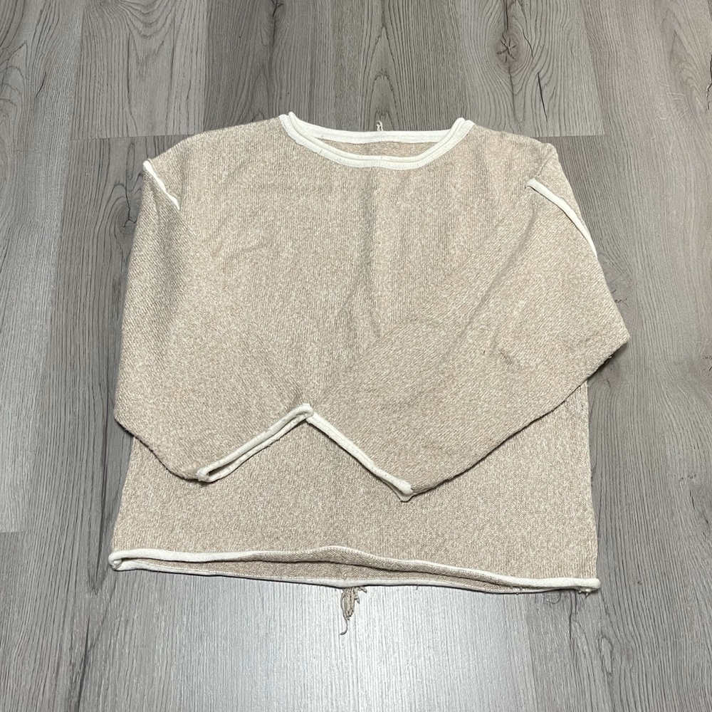 Rolled hem sweater with fringe detail on back